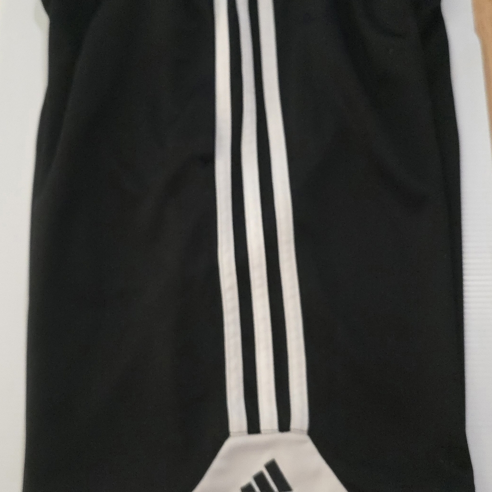 Adidas Black Kids Athletic Shorts with White Stripes.